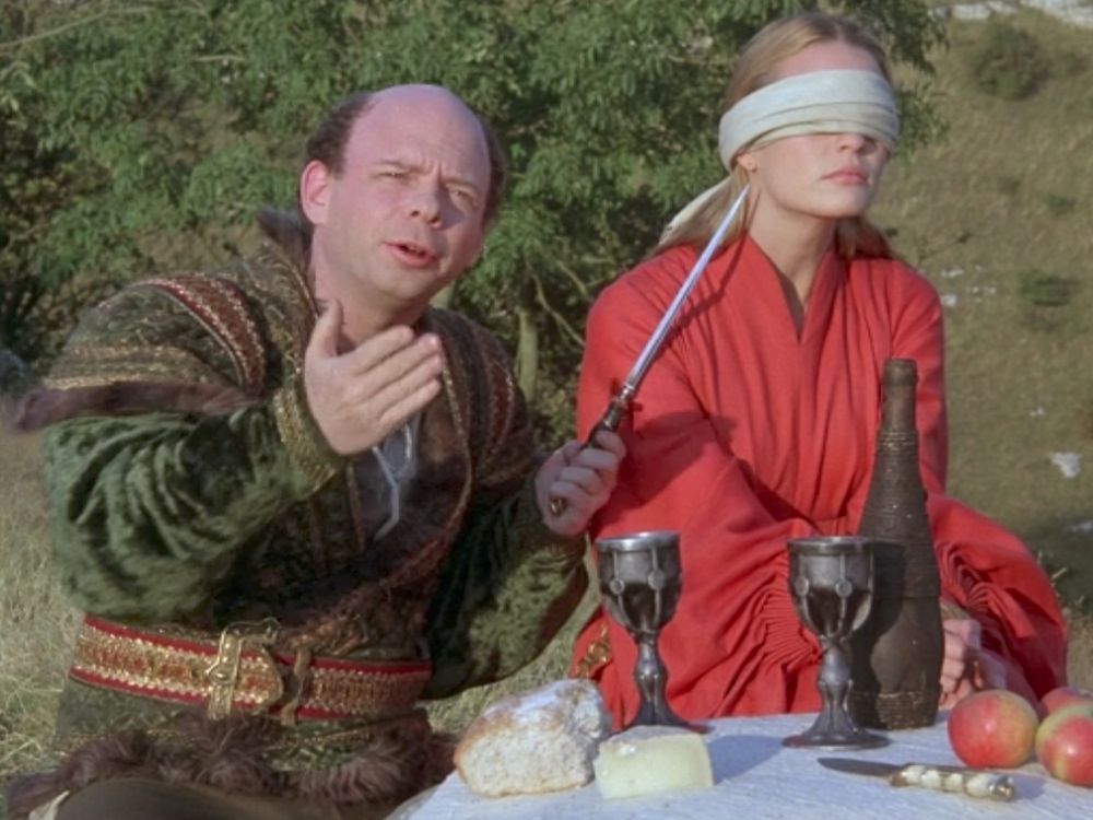 Wallace Shawn as Vizzini in The Princess Bride holding a knife to the throat of Princess Buttercup (Robin Wright). In this seen he's accusing Wesley of "trying to kidnap what I've rightfully stolen."