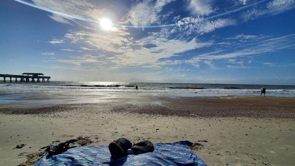 A picture of Tybee Island Beach looking easy with the pier to the left.
