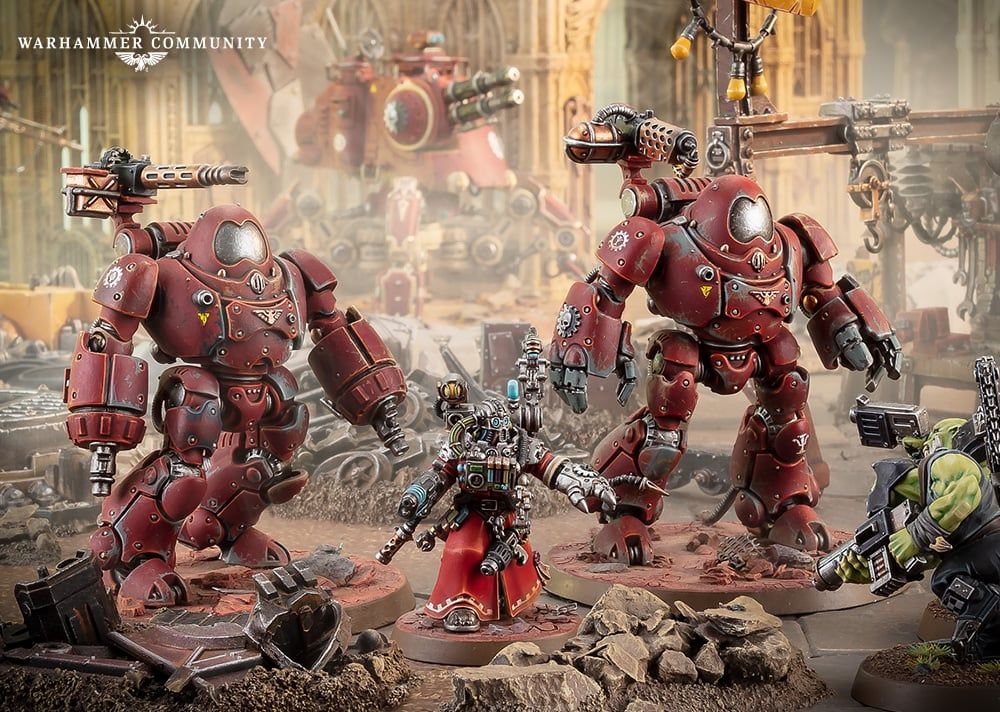 An image from a game of Warhammer 40,000 with an Adeptus Mechanicus Techpriest and two combat robots about to be completely obliterated by the Space Ork boyz entering from the right side of the image. 