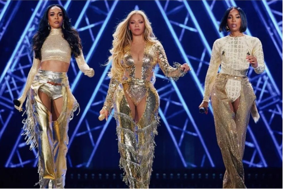 Destiny's Child--Michelle, Beyonce, and Kelly--is wearing gold chaps and walking out during the Cowboy Carter tour.