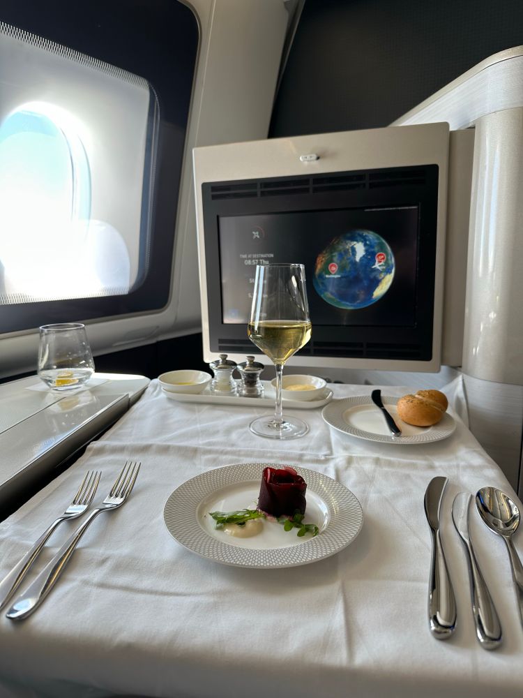 i redeemed points to fly first on british airways and thus my inflight dining comes with a white tablecloth, real silverware, high-end porcelain, and a glass of delicious white burgundy in a dartington crystal glass. it’s all situated in front of the in-flight map on the IFE screen because that is the most interesting thing about flying