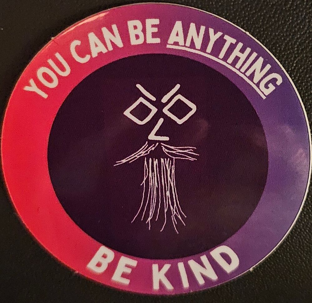 A round sticker with the words You can be anything, be kind.