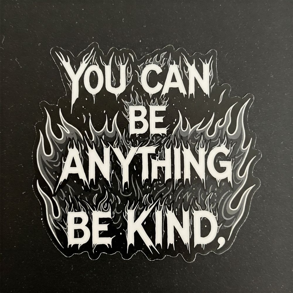 A sticker saying You can be anything be kind in white lettering on a black background