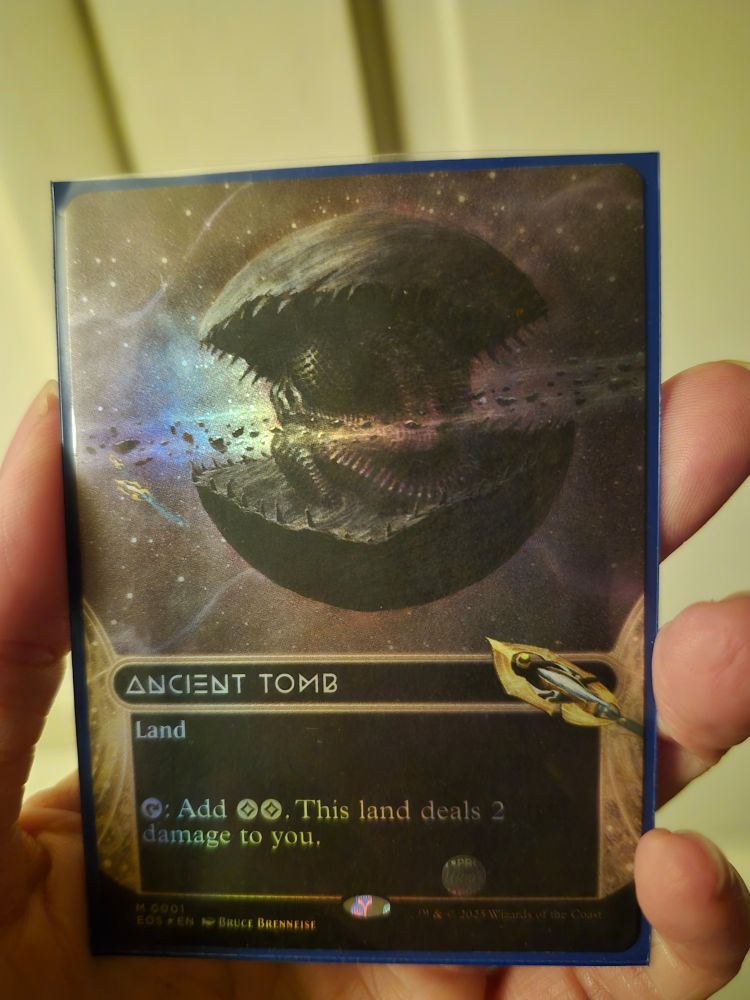 Foil, full art ancient tomb card.