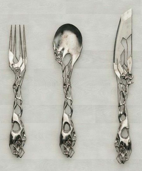 A cutlery set, knife on the right, spoon in the middle, fork on the left. It’s silver, and looks like it was made by elves, but also slightly art nueva. The handles and bit you’d use are in the same style. There’s a hole in the spoon. Yup 