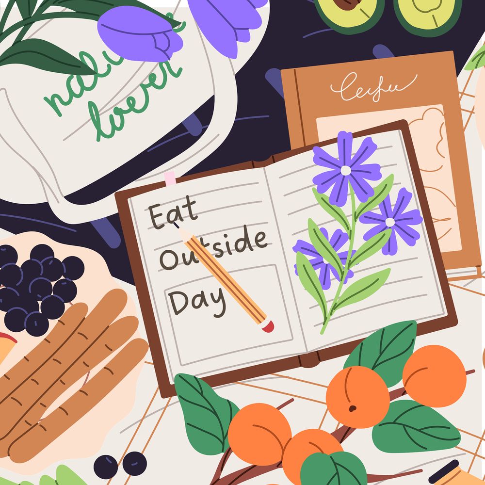 A messy picnic scene with a notebook that says "eat outside day."