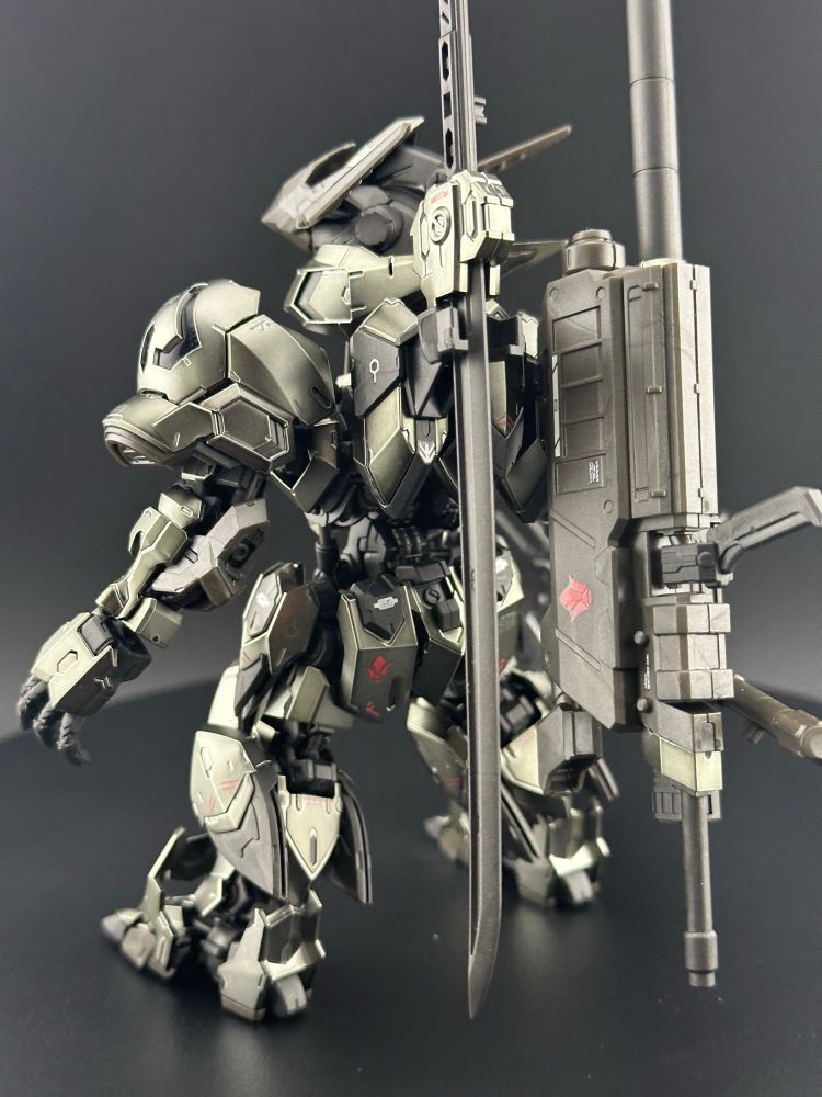 A light box photo of the master grade super deformed Barbatos (Iron-Blooded Coating) Gundam plastic model kit, from Iron-Blooded Orphans. A detail shot of the back side, showing off the sword and rifle on their individual, articulated holsters 