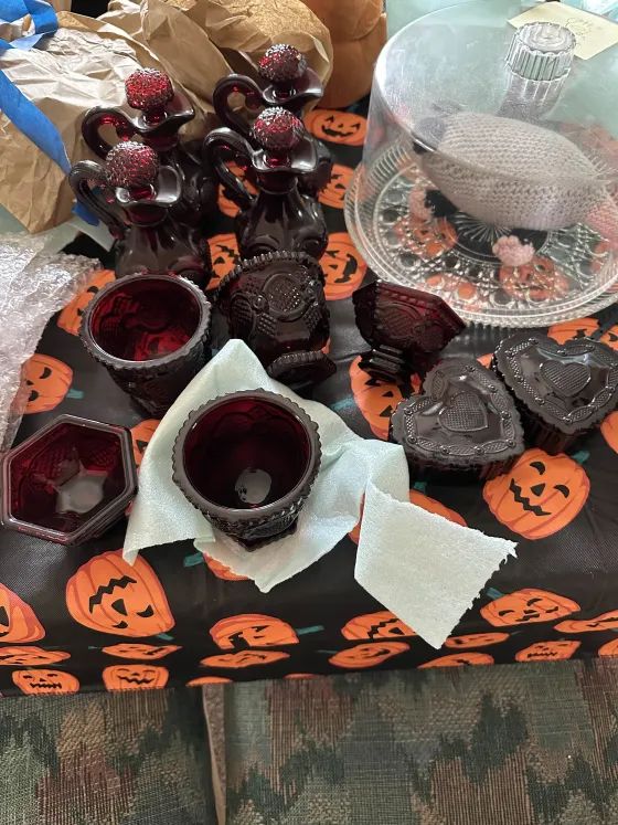 Ruby red dish ware on a halloween table cloth