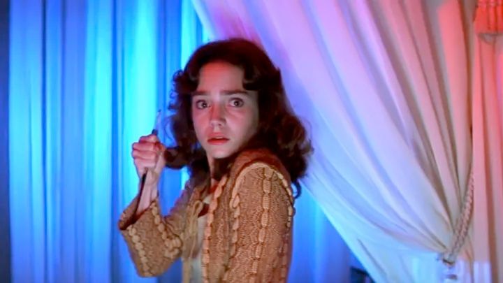susie bannon from suspiria holding a spike