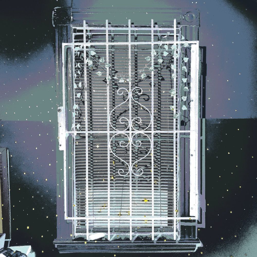 A sankofa gate closed with blinds in front of projected lights and stars.