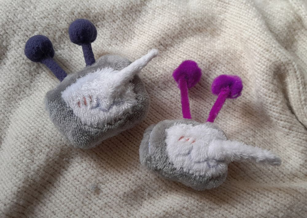 A picture of two versions of the same mini plush piece, of Mr. Ant Tenna, character from Deltarune.