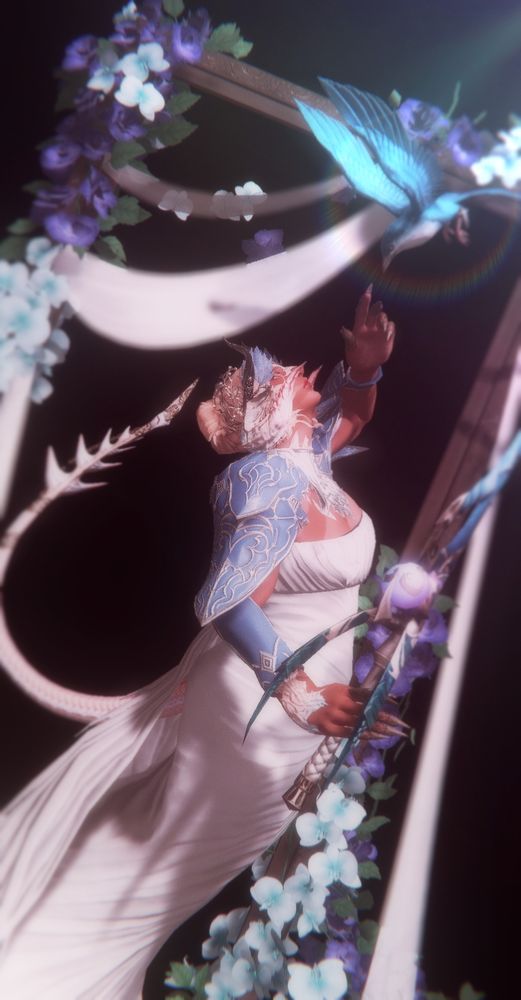 Ryuhiko (Raen Au Ra, he/him and she/her pronouns) glad in a white gown with a blue shawl, surrounded by a frame with flowers and drapery, clutches a blade fashioned after Seiryu's likeness. He reaches out with his opposite hand, faced away from the viewer, to meet the touch of a bluebird that descends to meet him. 