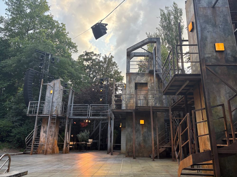 Industrial chic metallic theatre set in open air 