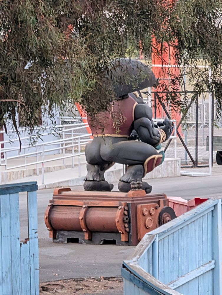 A statue of a dude from behind with a big butt