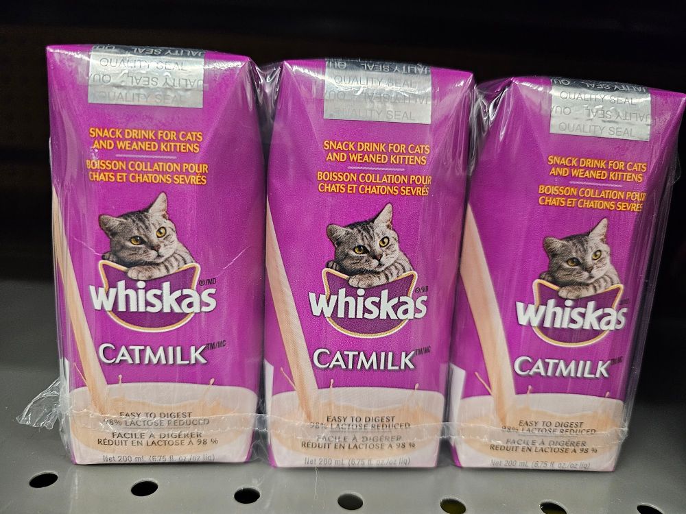 A small juice box labeled "whiskas cat milk."