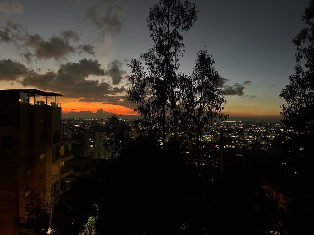 The sun has set and an orange glow remains over bogota 