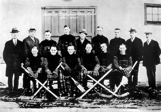 Black and white group photo of the Hamilton Professional Hockey club. Text on image is illegible.