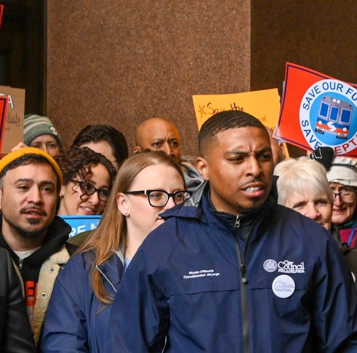 I am wearing an Eagles hat in crowd at rally for SEPTA funding 