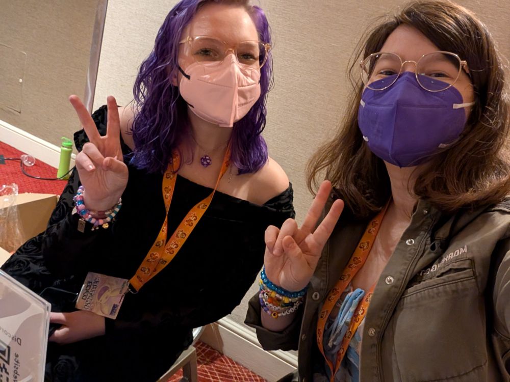 two girlies showing off peace signs 