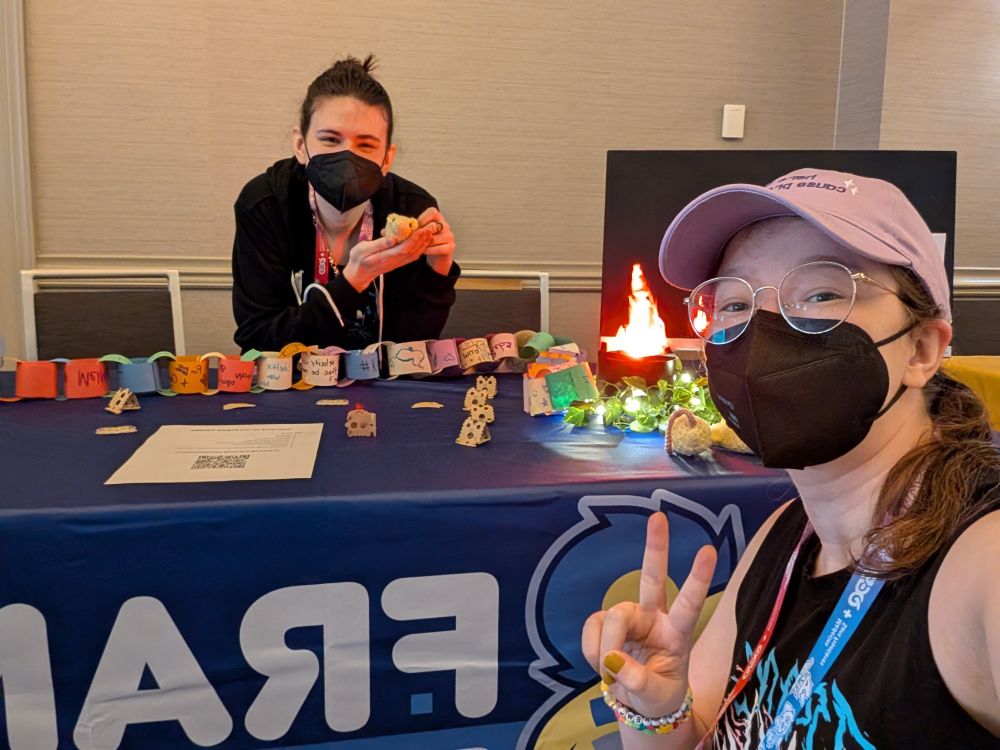 A selfie in front of the Frame Fatales table with Quacksilver and a "Trans Rights" shirt designed by K_Duffles from the Yetee