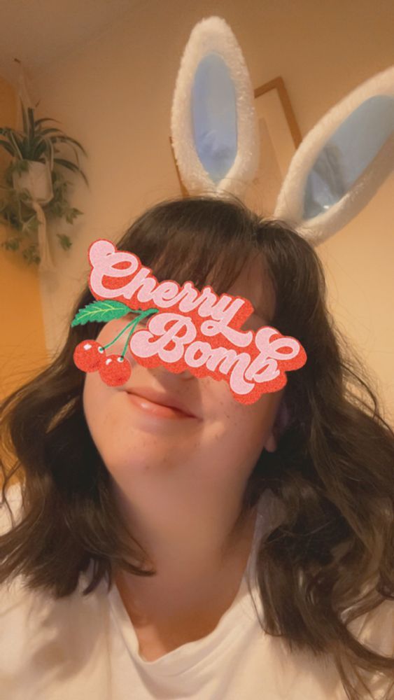 Selfie of me, a brown short haired girl, smiling with white bunny ears on 