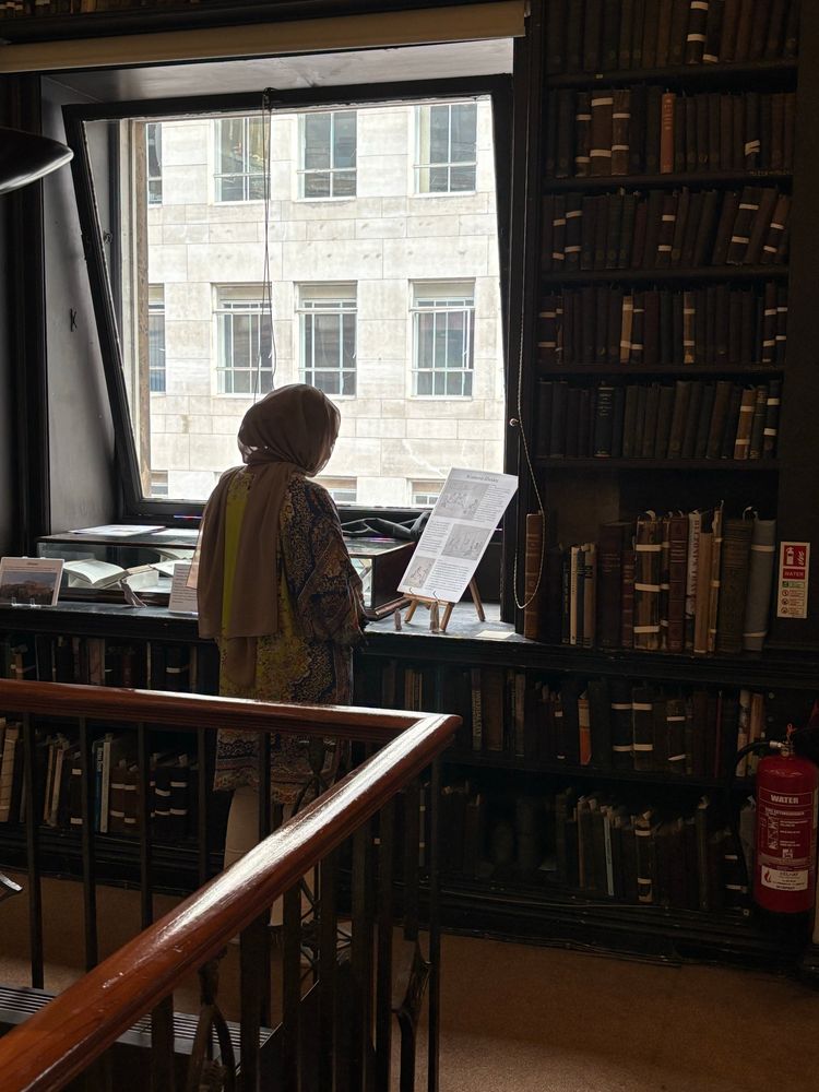 A woman looking at an exhibition in a library
