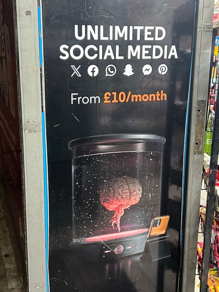 A poster saying ‘Unlimited social media from £10/month’, with an image of a brain in a vat of water.