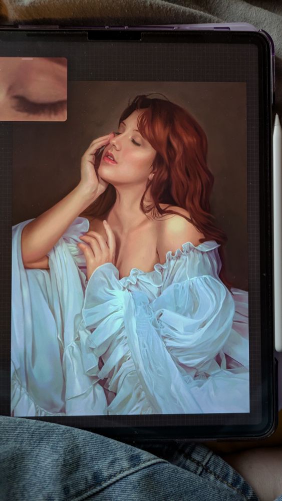 Quick photo of a work in progress painting on an iPad. The painting itself is a woman with red hair in a ruffled pale blue dress
