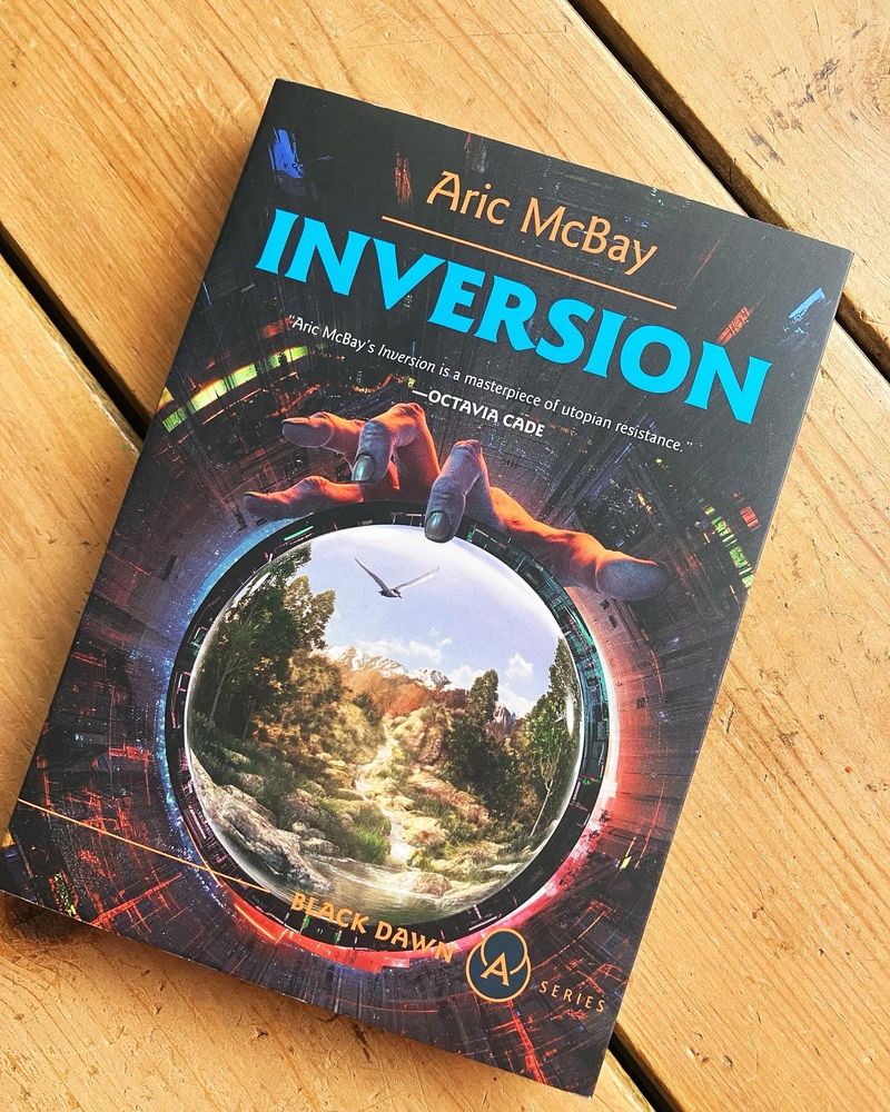 Cover of inversion, a spaceship looking tunnel leading to a portal that looks out on untouched nature