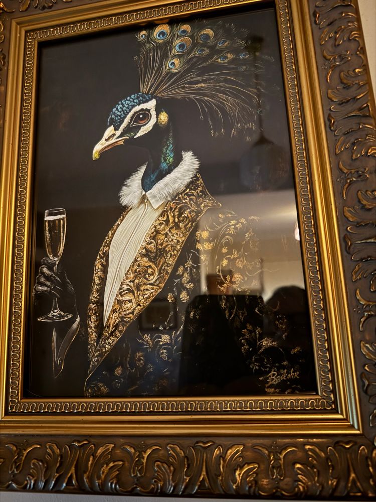 A peacock in an ornate smoking jacket raising a toast. 