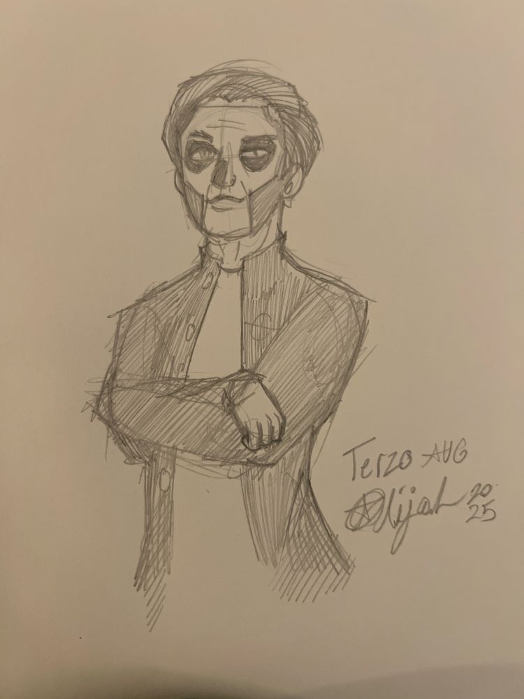 Close up of Terzo with his arms folded. He stands there looking proud.