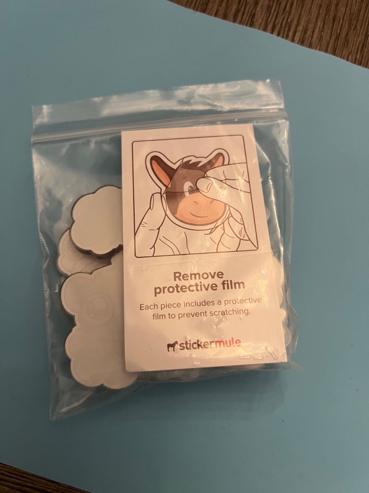 The card says “Remove protective film. Each piece includes a protective film to prevent scratching. Sticker Mule”