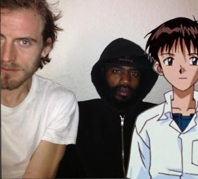 Photo of Death Grips but Andy has been replaced with Shinji from Neon Genesis Evangelion 