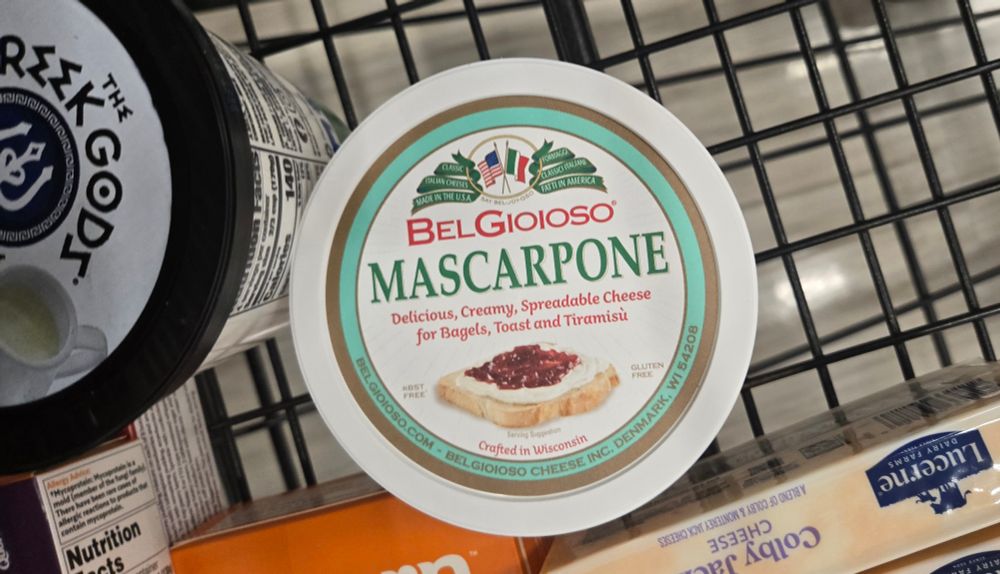 A write shopping cart with a tib of mascarpone cheese tub.