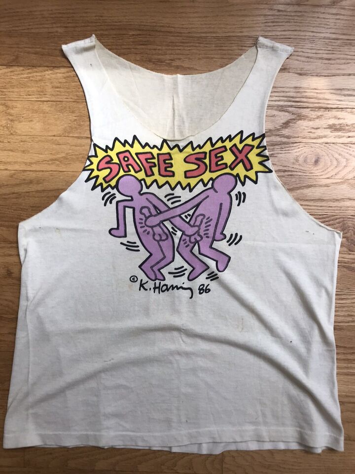 A Keith Haring drawing on a t-shirt. It shows two men jacking each other off with the words “SAFE SEX"