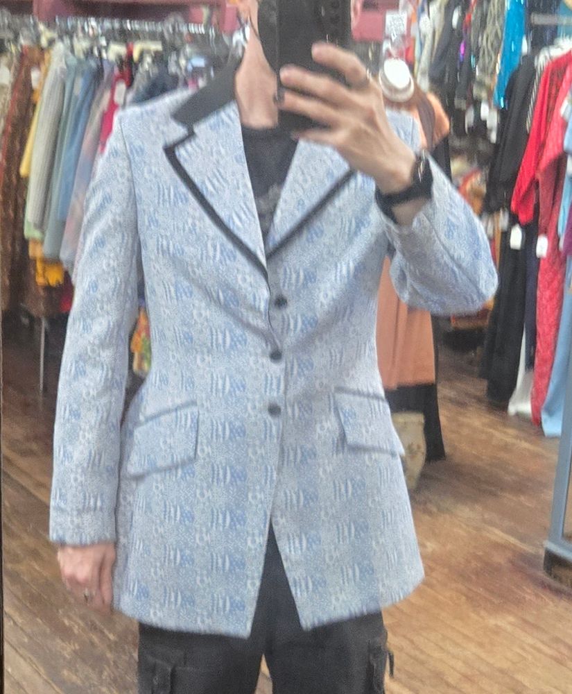 A single bested powder blue tuxedo jacket . Awful color aside, it's a great fit the jacket falls long, mud -thigh. 