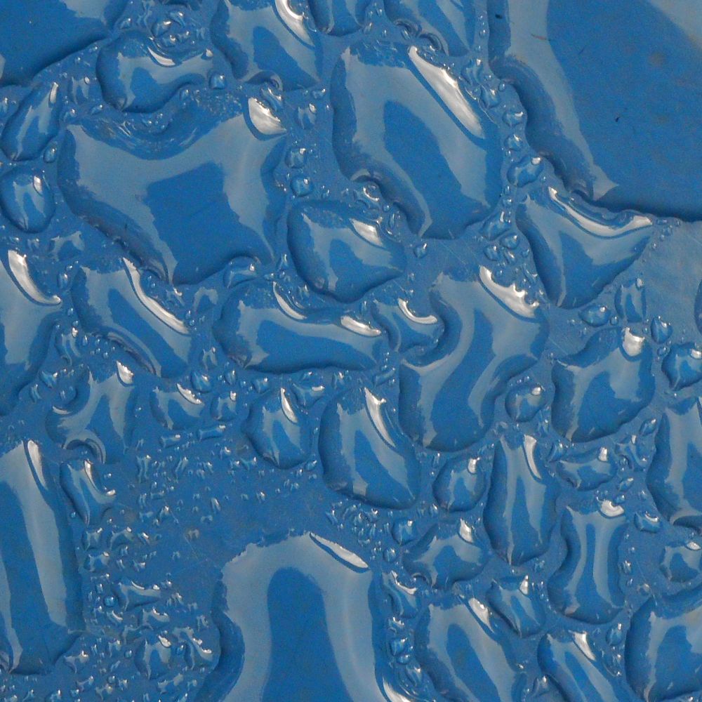 droplets of water on a blue plastic surface