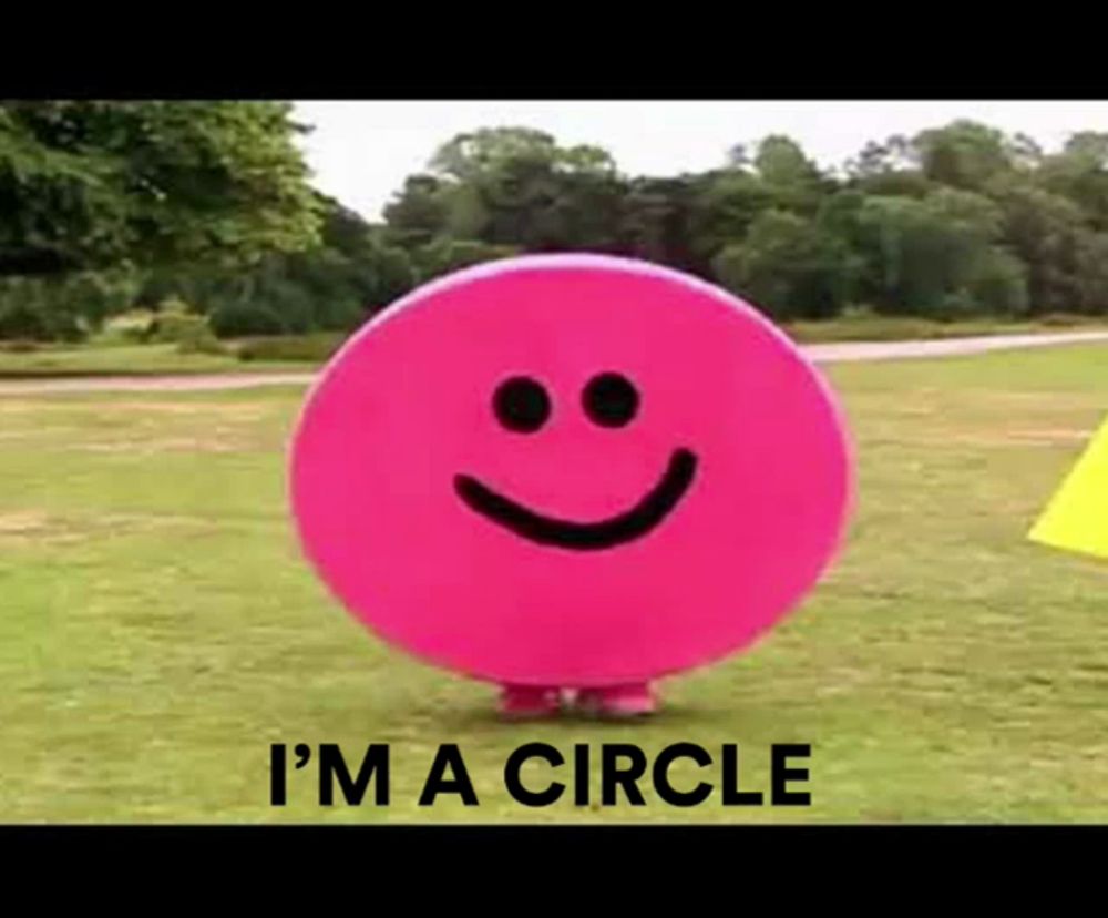 a pink circle with a smiley face on it and the words i 'm a circle below it