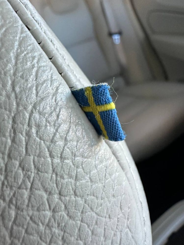 The tiny Swedish flag tag sewn into the leather of the front passenger seat of Savrin's new vehicle. 