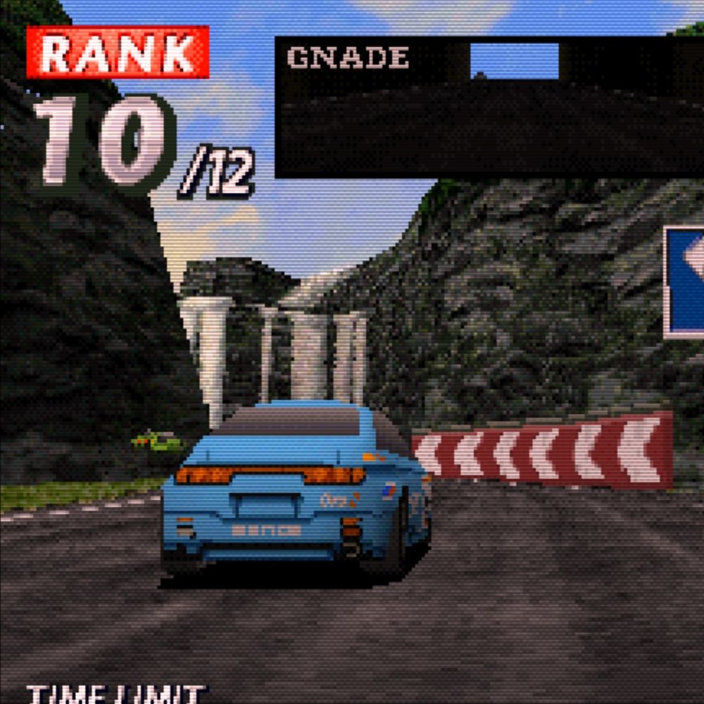blue car driving through a ravine with a waterfall