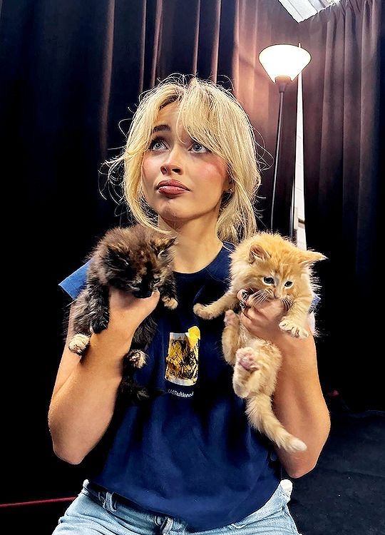 sabrina carpenter holding two kittens