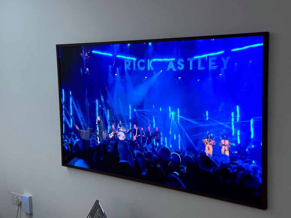 A concert stage with a big “RICK ASTLEY” sign at the top.