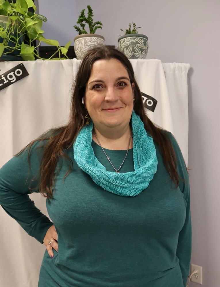 Caed modeling a simple cowl in a teal green 