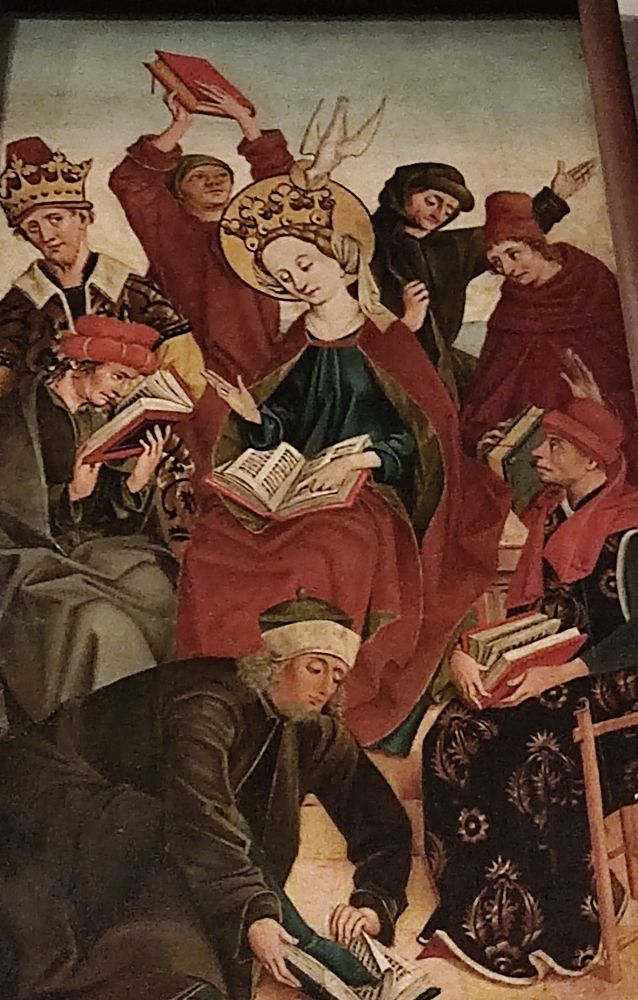 painiting of a woman with a crown and a halo looking in a book and a bunch of men around her confusedly looking in books (st catharine confounding the learned men)