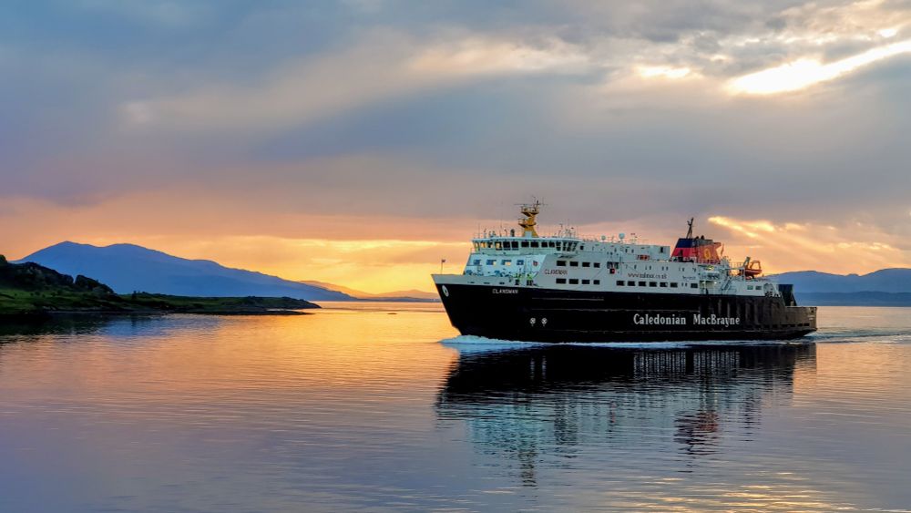 Calmac ferry returning to Oban with sunset in the background 
