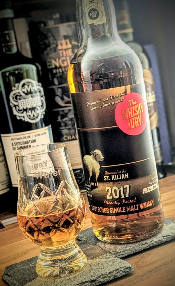 A bottle of #StKilian whisky and a poured dram next to it. 