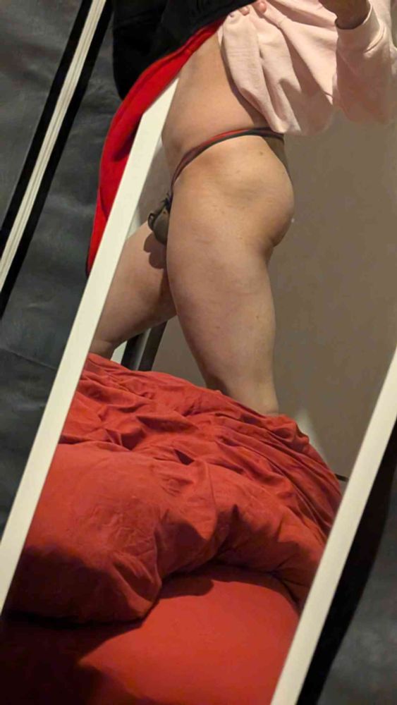 puppy leg facing left while caged in chastity cage