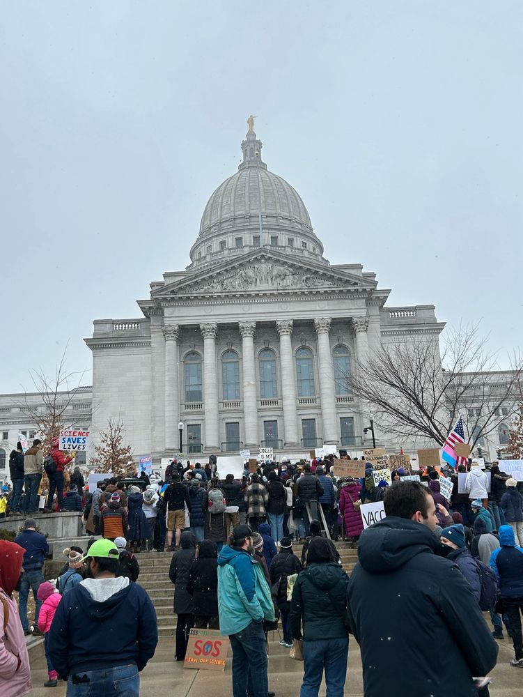 Capitol building with crowd out front in Madison, WI