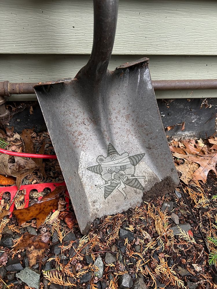 A shovel with the Self Help Radio logo on it.