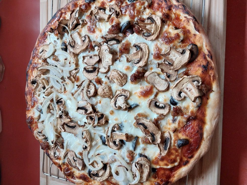 Made a pizza with sausage, mushrooms, cheese, and olives. It was tasty